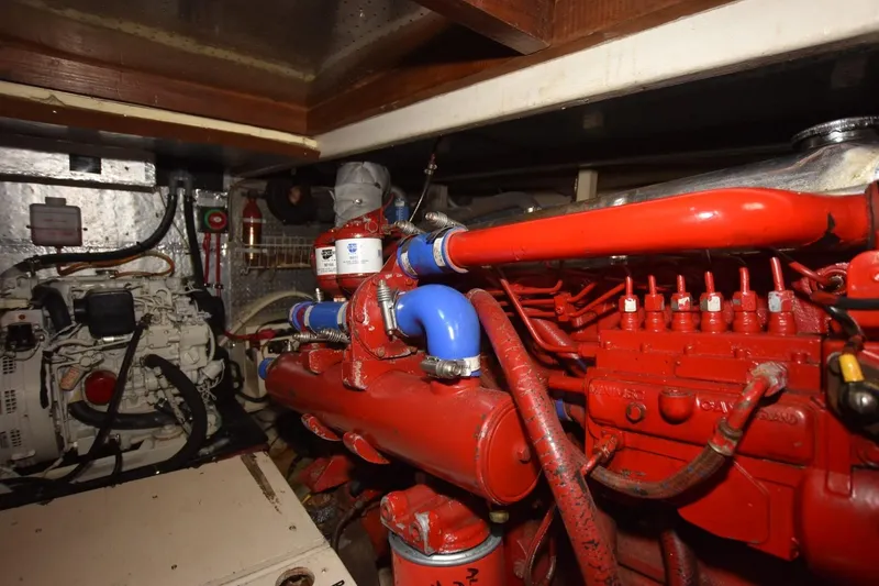 Slide: The Image of Engine room of 1987 Hartman-Palmer Offshore 38 Sundeck with red and blue components. - 27