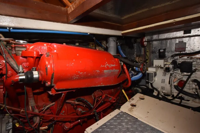 Slide: The Image of Engine room of 1987 Hartman-Palmer Offshore 38 Sundeck with red machinery and wiring. - 28