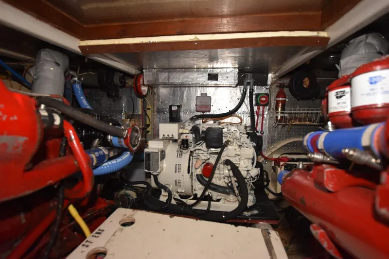 Slide: The Image of Engine room of 1987 Hartman-Palmer Offshore 38 Sundeck with visible machinery and pipes. - 29