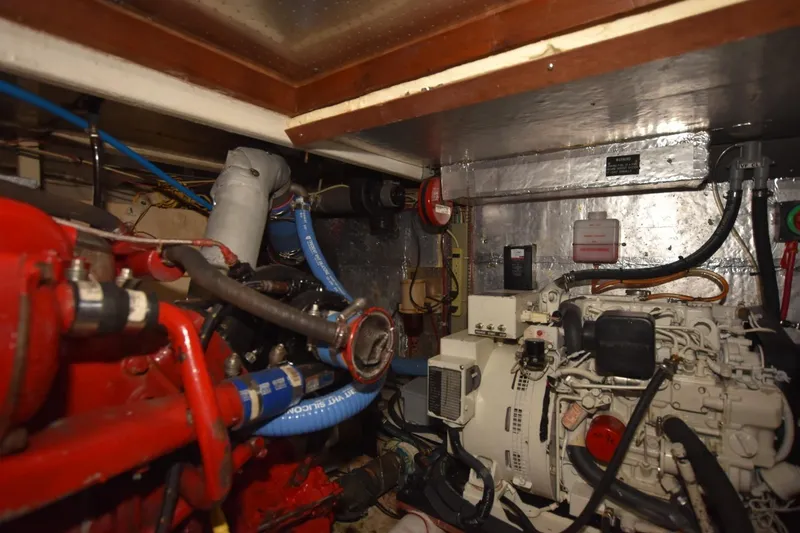 Slide: The Image of Engine room of 1987 Hartman-Palmer Offshore 38 Sundeck with visible machinery and piping. - 30