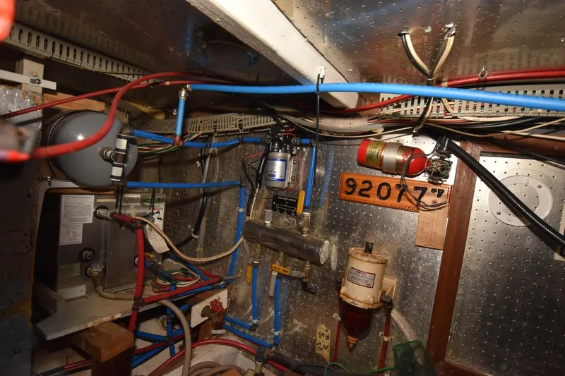Slide: The Image of Engine room of 1987 Hartman-Palmer Offshore 38 Sundeck with wiring and equipment. - 32