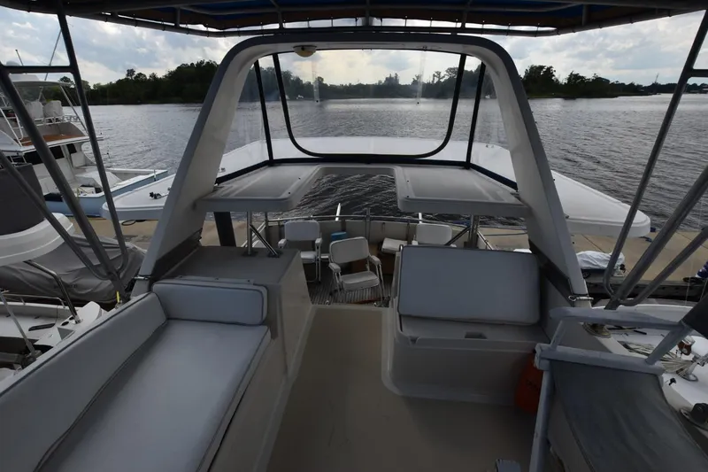 Slide: The Image of 1987 Hartman-Palmer Offshore 38 Sundeck, featuring spacious seating and scenic water view. - 4