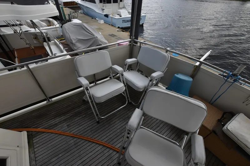 Slide: The Image of Deck of 1987 Hartman-Palmer Offshore 38 Sundeck with chairs and marina view. - 5