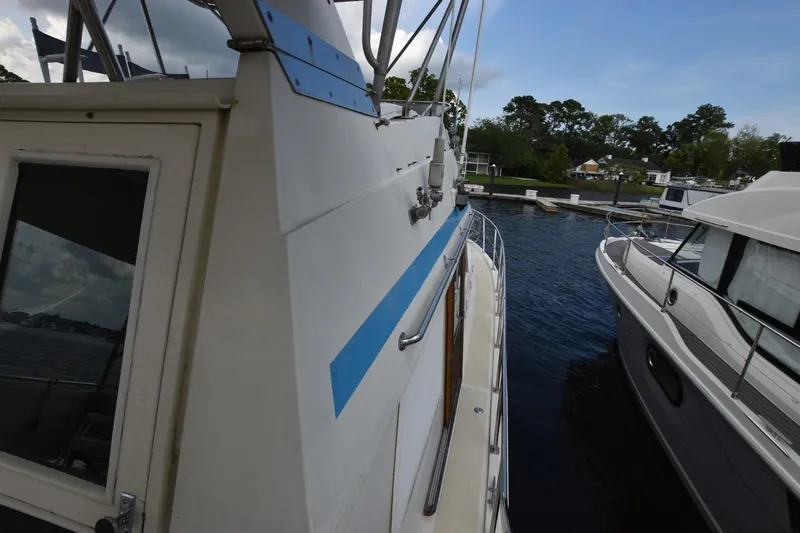 Slide: The Image of 1987 Hartman-Palmer Offshore 38 Sundeck yacht docked beside another boat. - 6