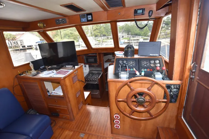 Slide: The Image of Interior of 1987 Hartman-Palmer Offshore 38 Sundeck with helm, TV, and navigation equipment. - 9
