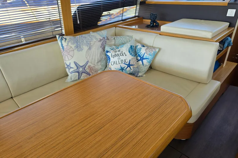 Slide: The Image of Interior of 2020 Greenline 40 yacht with cozy seating and decorative pillows. - 10