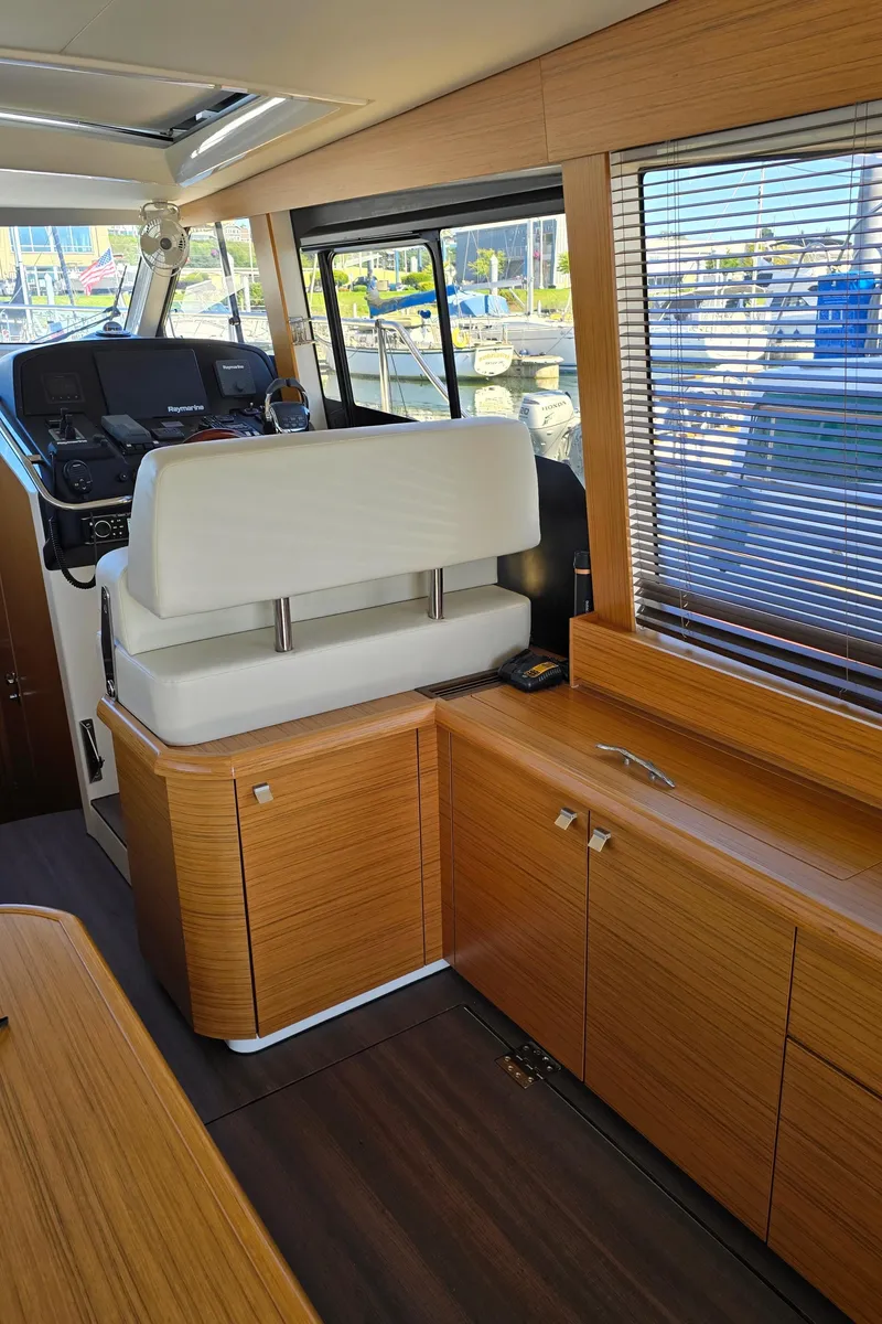 Slide: The Image of Interior of a 2020 Greenline 40 yacht with modern wood finish and helm station. - 14