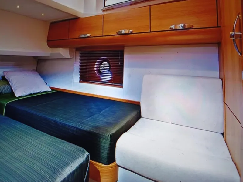 Slide: The Image of Interior of 2020 Greenline 40 yacht cabin with twin beds and wooden cabinetry. - 16