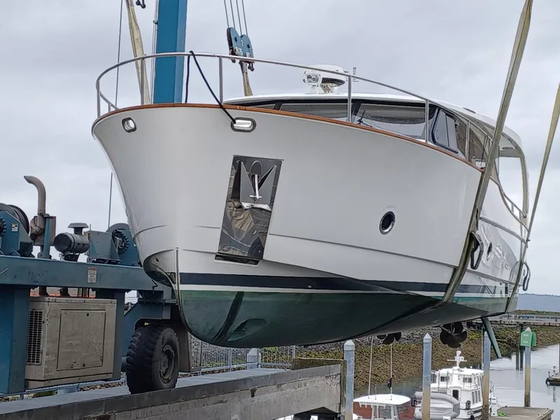Slide: The Image of 2020 Greenline 40 yacht being lifted by a crane at a marina. - 2