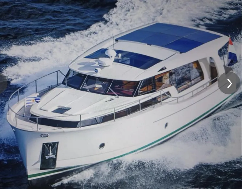 Slide: The Image of 2020 Greenline 40 yacht cruising on open water, showcasing sleek design and solar panels. - 3