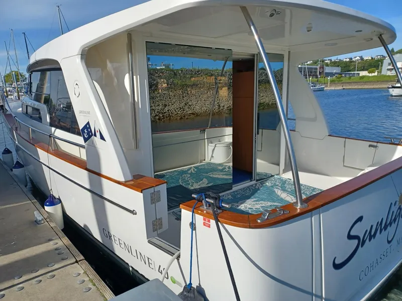 Slide: The Image of 2020 Greenline 40 yacht docked at marina, showcasing sleek design and spacious deck. - 5