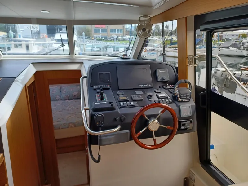 Slide: The Image of Helm of 2020 Greenline 40 yacht with navigation equipment and wooden steering wheel. - 7