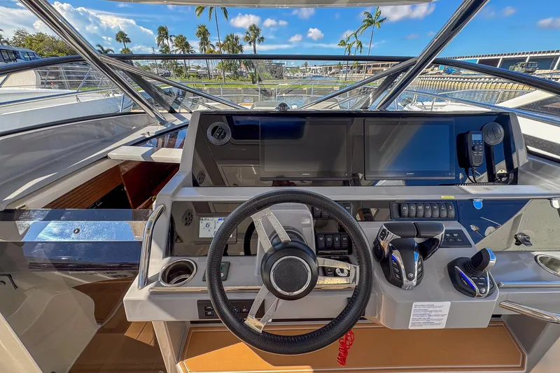 Slide: The Image of Cockpit of 2022 Jeanneau Leader 12.5 WA with modern navigation equipment and steering wheel. - 17