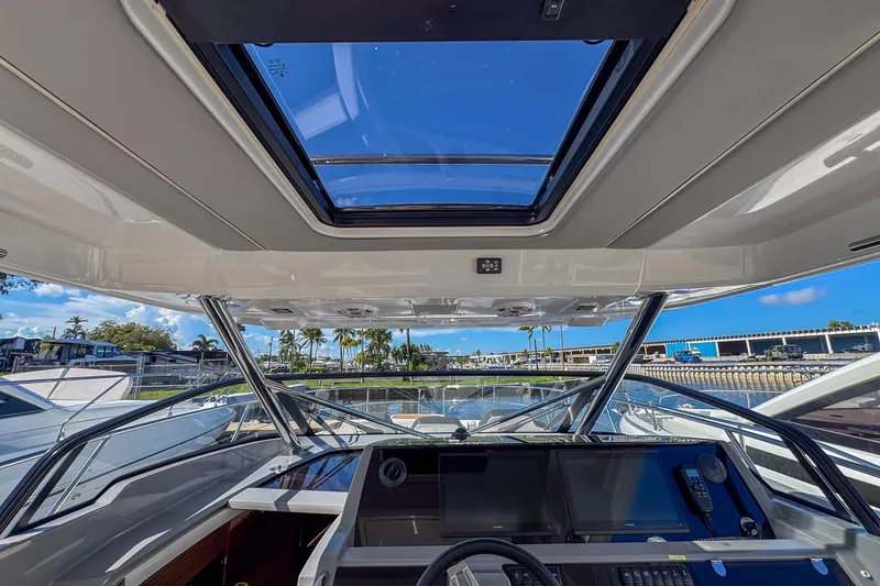 Slide: The Image of Interior view of 2022 Jeanneau Leader 12.5 WA boat cockpit with skylight and navigation controls. - 20