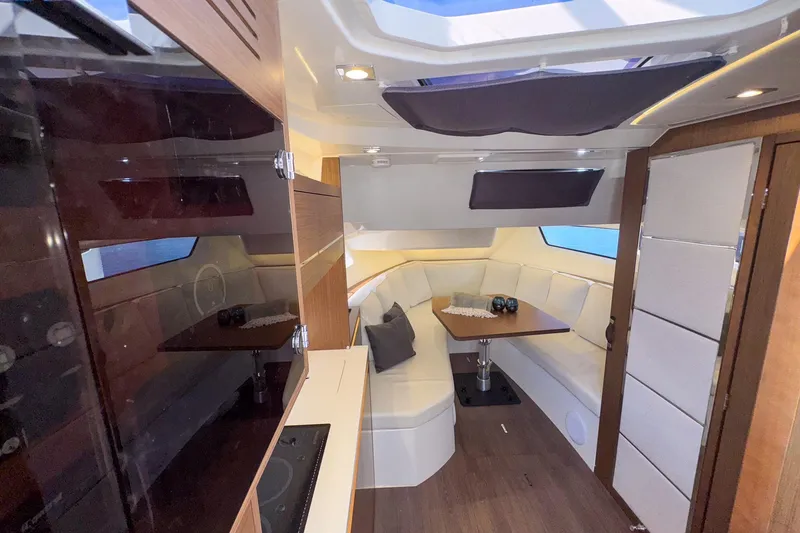 Slide: The Image of Luxurious interior of 2022 Jeanneau Leader 12.5 WA yacht with elegant seating and dining area. - 22