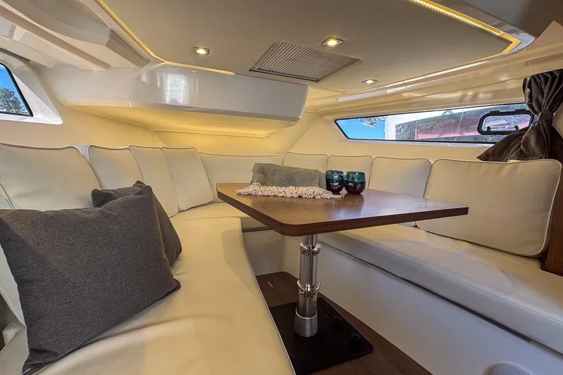Slide: The Image of Luxurious interior of 2022 Jeanneau Leader 12.5 WA yacht with elegant seating and table. - 23