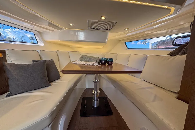Slide: The Image of Luxurious interior of 2022 Jeanneau Leader 12.5 WA with elegant seating and table. - 24