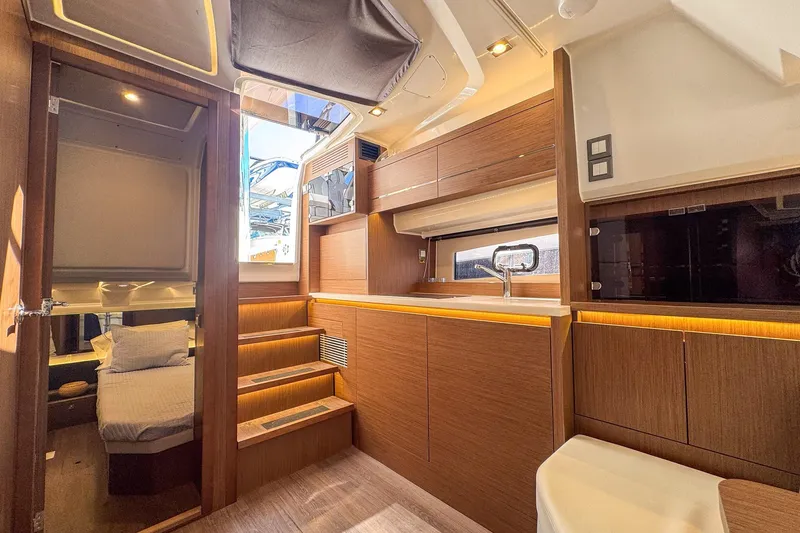 Slide: The Image of Luxurious interior of 2022 Jeanneau Leader 12.5 WA yacht with modern wood finish. - 25