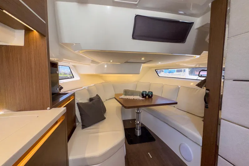 Slide: The Image of Luxurious interior of 2022 Jeanneau Leader 12.5 WA yacht with elegant seating and table. - 26
