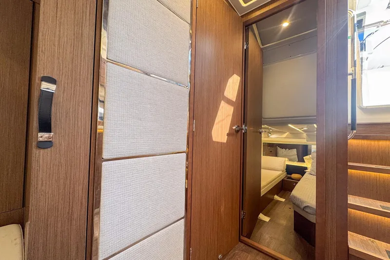 Slide: The Image of Interior cabin of 2022 Jeanneau Leader 12.5 WA, featuring wood paneling and cozy bedding. - 28