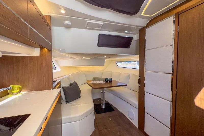 Slide: The Image of Luxurious interior of 2022 Jeanneau Leader 12.5 WA yacht with modern seating and dining area. - 34