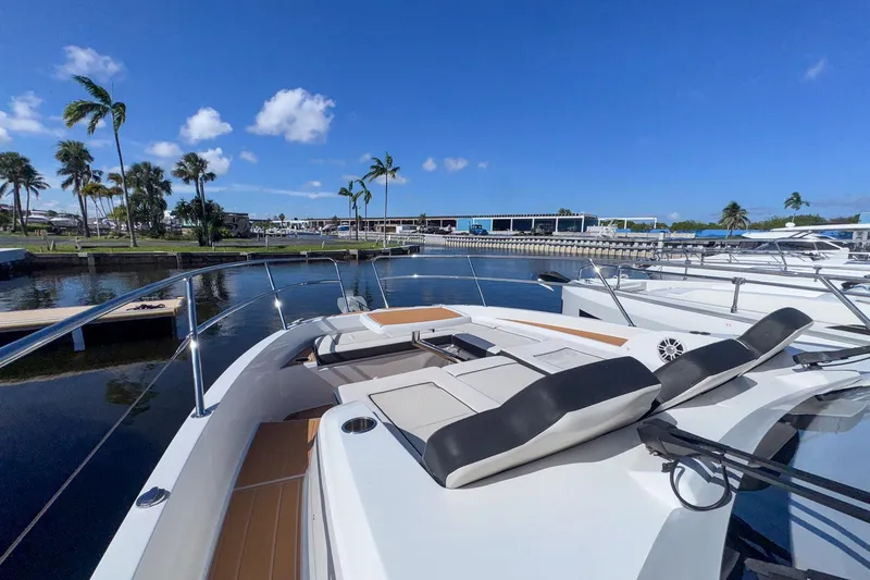 Slide: The Image of 2022 Jeanneau Leader 12.5 WA yacht docked in a sunny marina with palm trees. - 36
