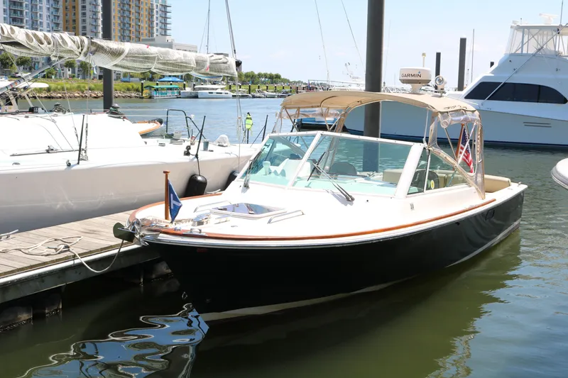 Slide: The Image of 2013 Hunt Harrier boat with beige seating and American flag at dock. - 12