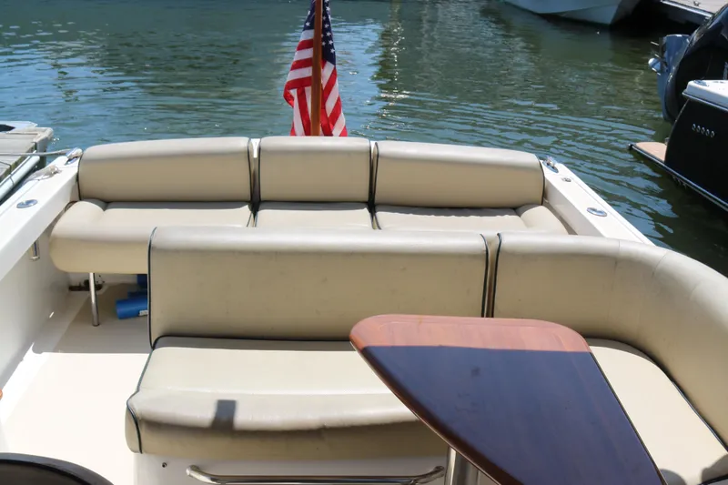Slide: The Image of 2013 Hunt Harrier boat docked at marina, featuring sleek design and canopy. - 14