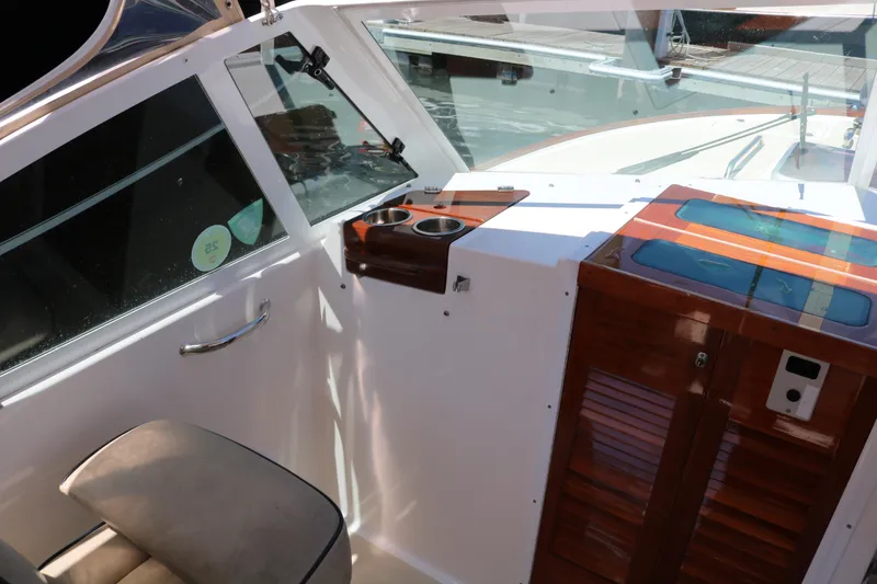 Slide: The Image of 2013 Hunt Harrier boat interior with seating and American flag on water. - 16