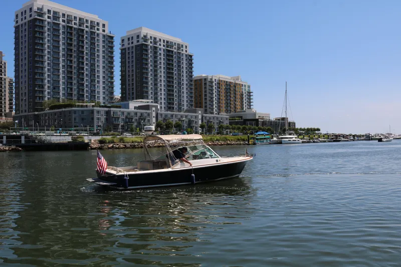 Slide: The Image of Interior of a 2013 Hunt Harrier boat featuring beige seating and wooden cabinetry. - 19
