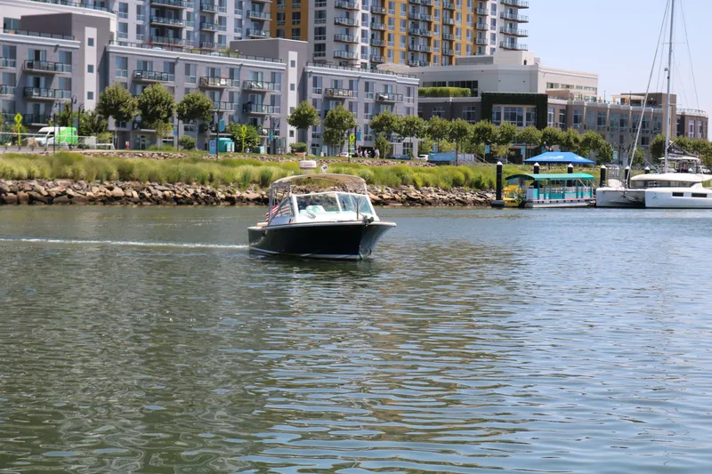 Slide: The Image of Boat cruising in urban harbor with modern buildings in background, Hunt Harrier 2013 model. - 23