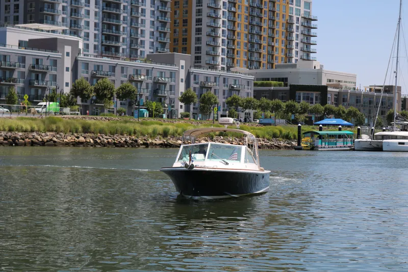 Slide: The Image of Boat cruising in urban harbor with modern buildings in background, Hunt Harrier 2013 model. - 24