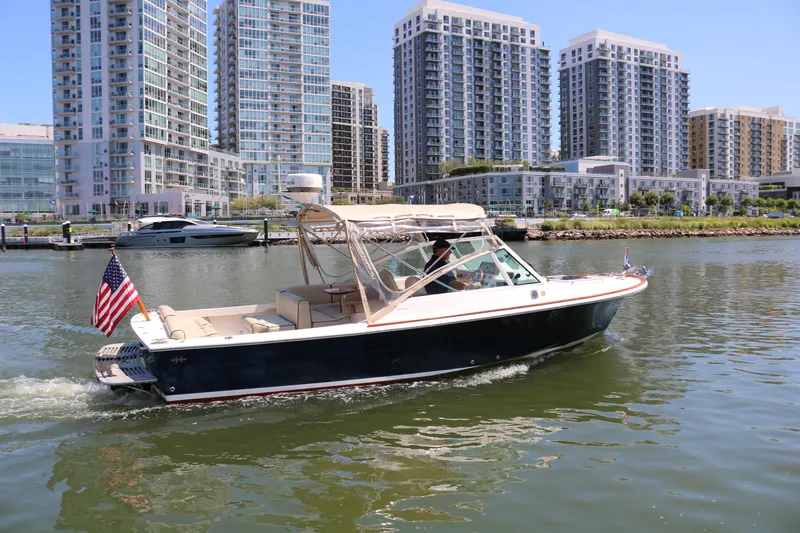 Slide: The Image of 2013 Hunt Yachts Harrier cruising near modern city skyline. - 39