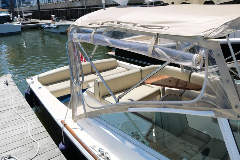 Slide: The Image of 2013 Hunt Harrier boat "Blazer" docked, displaying American flag, urban waterfront backdrop. - 4