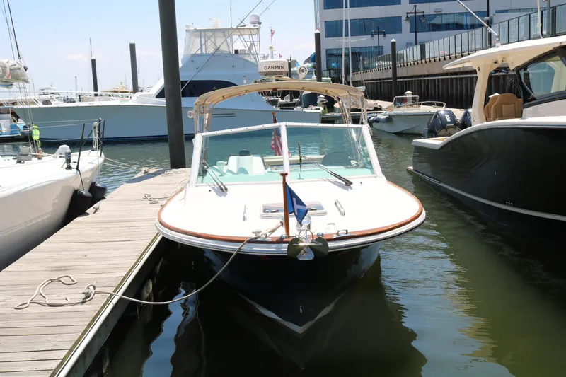 Slide: The Image of 2013 Hunt Harrier boat interior with cushioned seating and wooden table. - 7