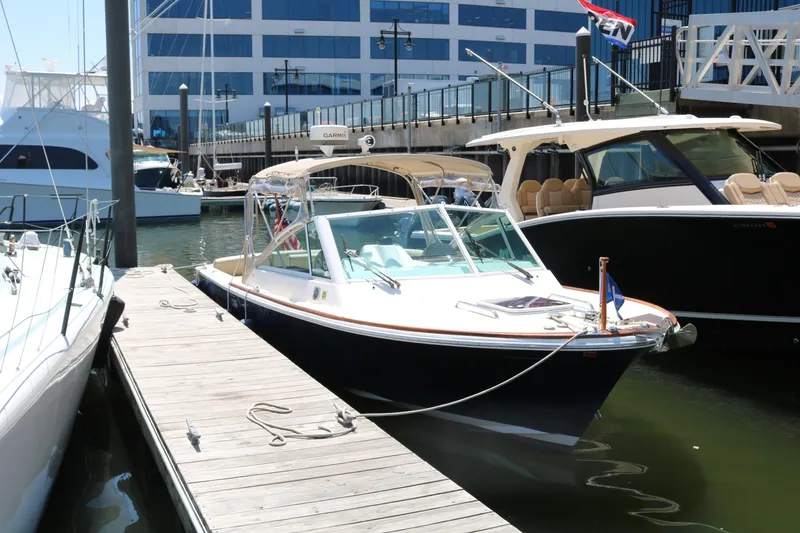 Slide: The Image of 2013 Hunt Harrier boat cockpit with wooden dashboard, steering wheel, and Garmin navigation system. - 8
