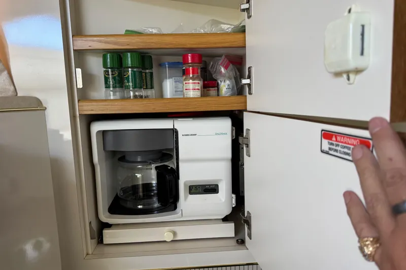 Slide: The Image of Cabinet with coffee maker and spices on a 1997 Sea Ray 400 Sundancer yacht. - 19