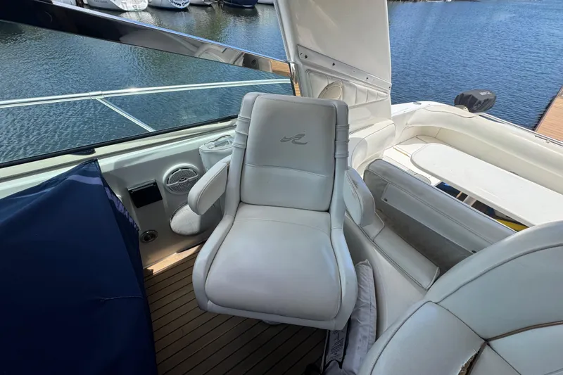 Slide: The Image of Luxurious seating on a 1997 Sea Ray 400 Sundancer yacht, docked by the water. - 2