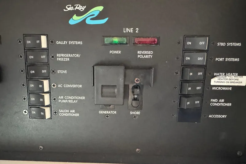 Slide: The Image of Control panel of a 1997 Sea Ray 400 Sundancer boat with various switches and indicators. - 24