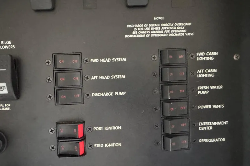 Slide: The Image of Control panel of a 1997 Sea Ray 400 Sundancer with labeled switches and instructions. - 25