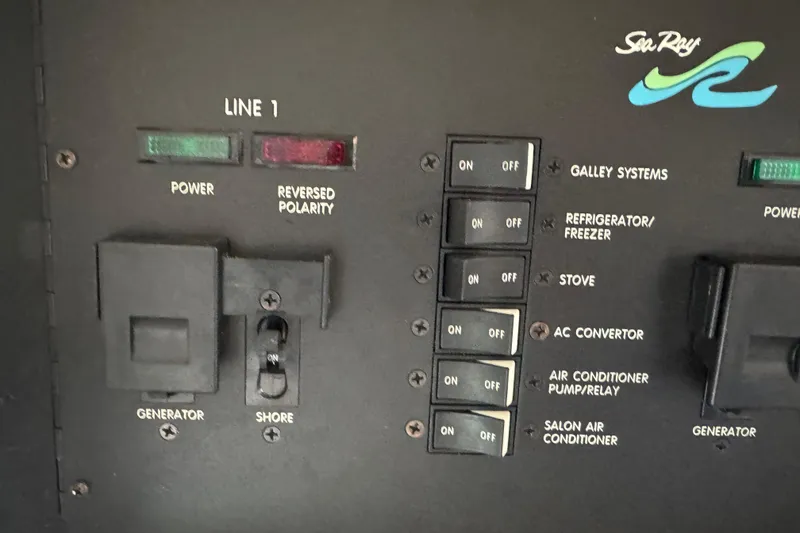Slide: The Image of Control panel of a 1997 Sea Ray 400 Sundancer boat with power switches. - 27