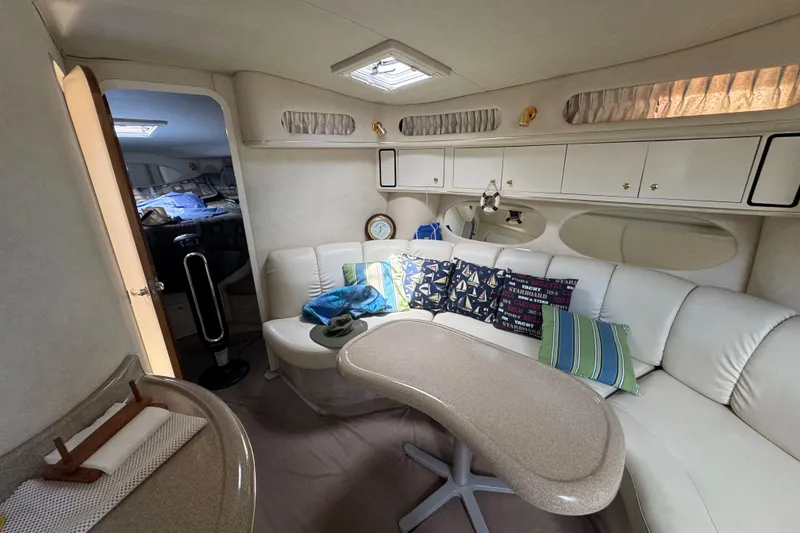 Slide: The Image of Interior of 1997 Sea Ray 400 Sundancer yacht with cozy seating and decorative pillows. - 31