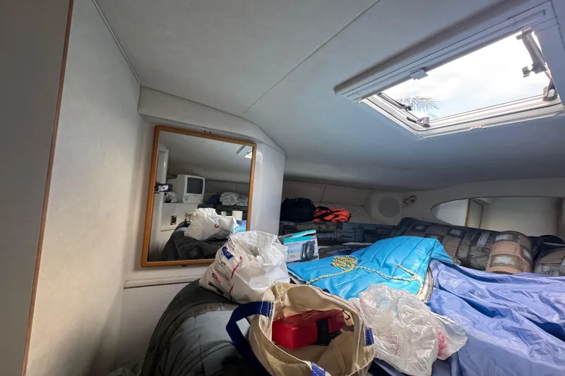 Slide: The Image of Interior cabin of 1997 Sea Ray 400 Sundancer with skylight and various items. - 34