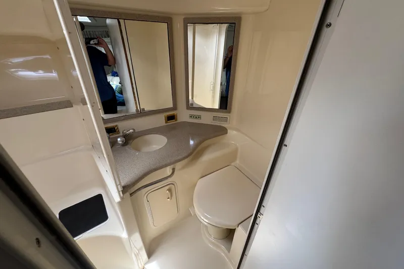 Slide: The Image of Bathroom interior of 1997 Sea Ray 400 Sundancer yacht, featuring sink and mirror. - 35