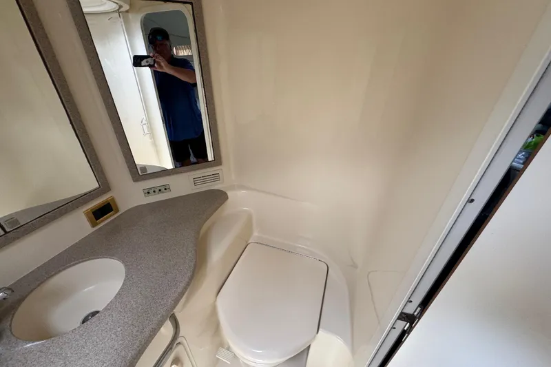 Slide: The Image of Bathroom interior of 1997 Sea Ray 400 Sundancer yacht, featuring sink and mirror. - 36