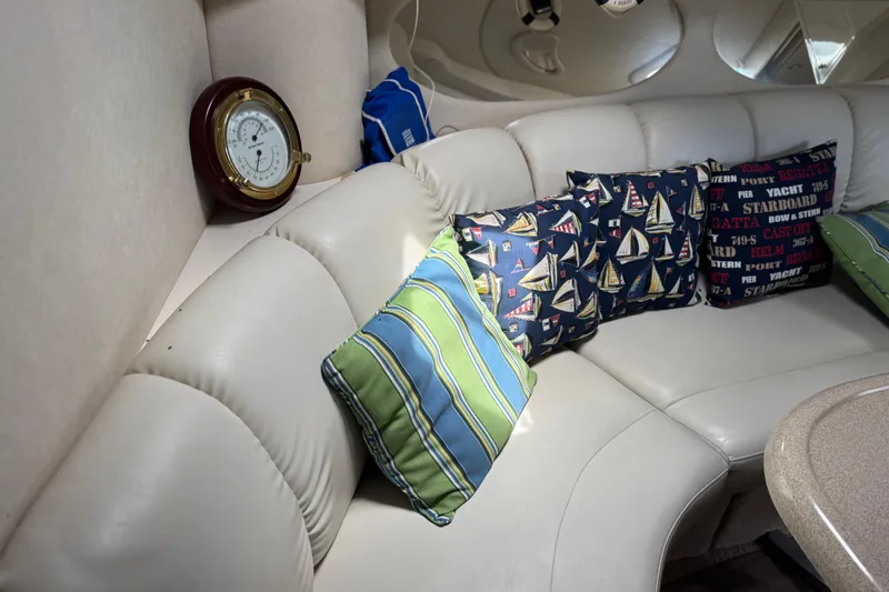 Slide: The Image of Luxurious interior of 1997 Sea Ray 400 Sundancer with nautical-themed cushions and barometer. - 42