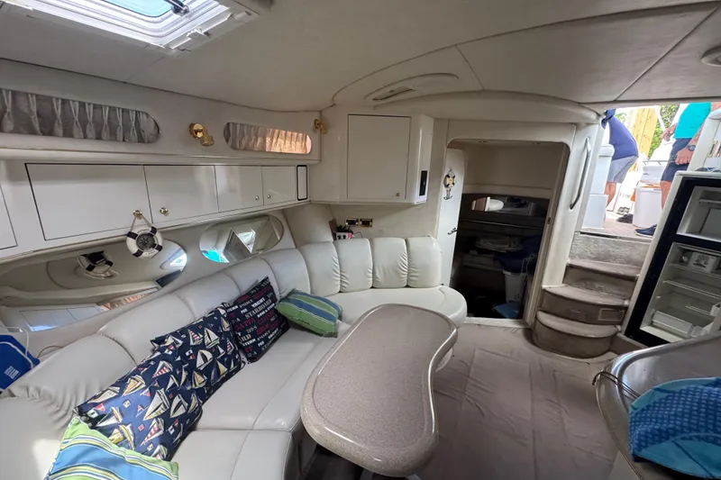 Slide: The Image of Interior of 1997 Sea Ray 400 Sundancer yacht with plush seating and nautical decor. - 44