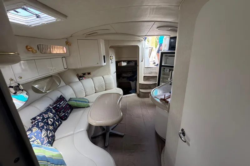 Slide: The Image of Interior of 1997 Sea Ray 400 Sundancer yacht with white seating and modern amenities. - 48
