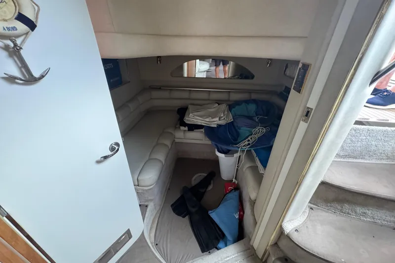 Slide: The Image of Interior cabin of a 1997 Sea Ray 400 Sundancer with seating and storage. - 50
