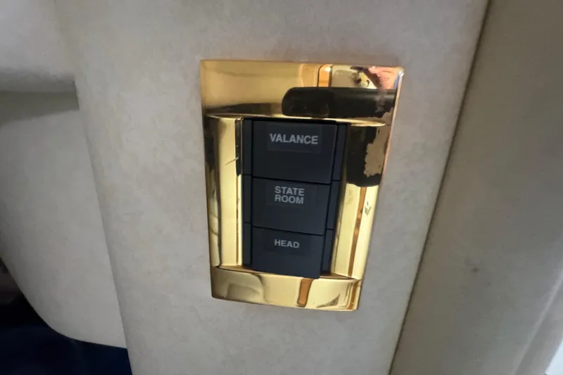 Slide: The Image of Gold switch panel on 1997 Sea Ray 400 Sundancer yacht interior. - 52